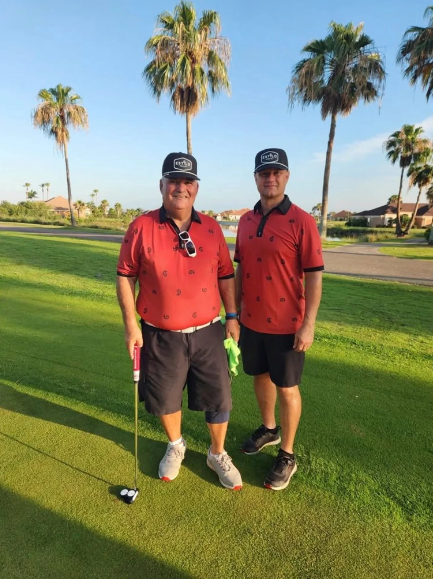 Golfers wearing red Estilo Golf Co. polos together on the course.
